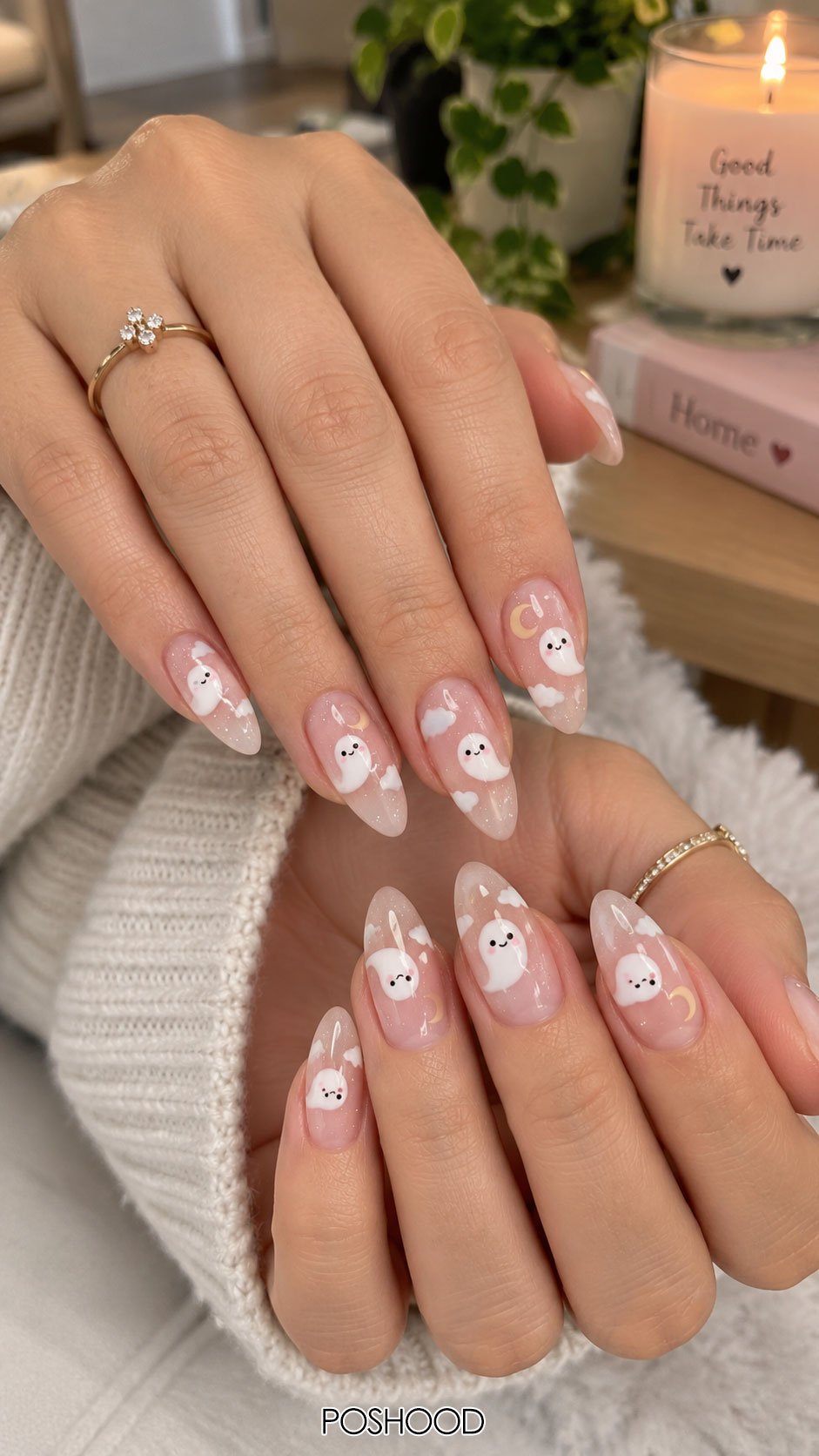 Cute Halloween nails ideas featuring white ghost nail art, crescent moons, and clouds on soft pink almond-shaped nails.