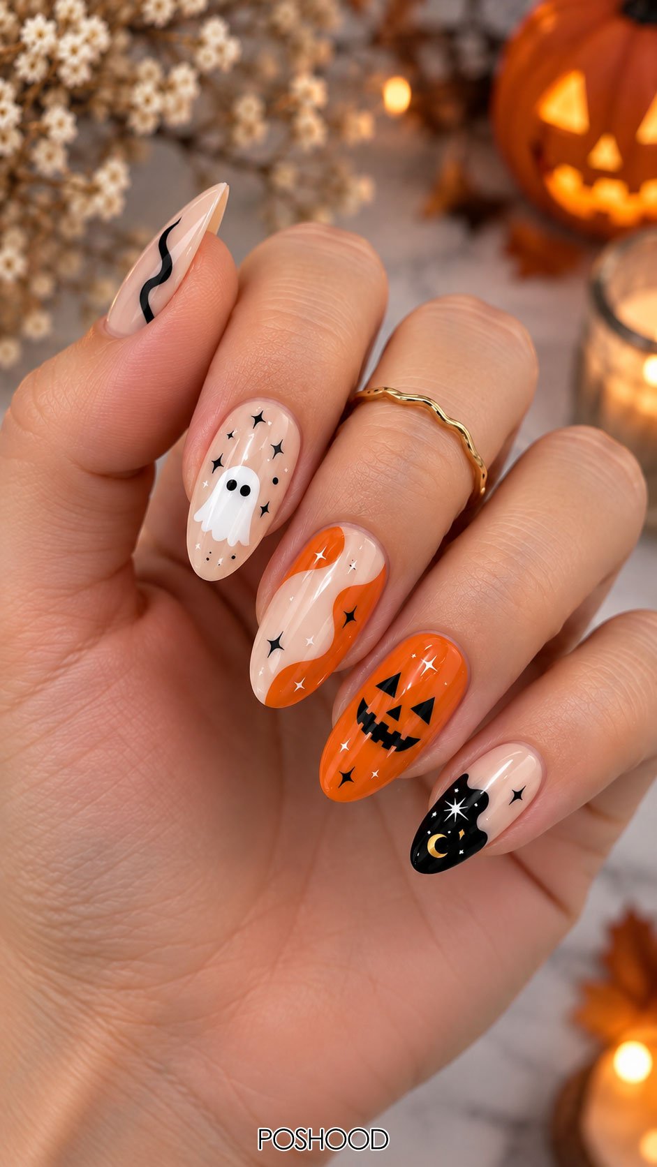 Cute Halloween nails ideas with orange pumpkin faces, white ghost nail art, black cat designs, and spooky stars on almond-shaped nails.