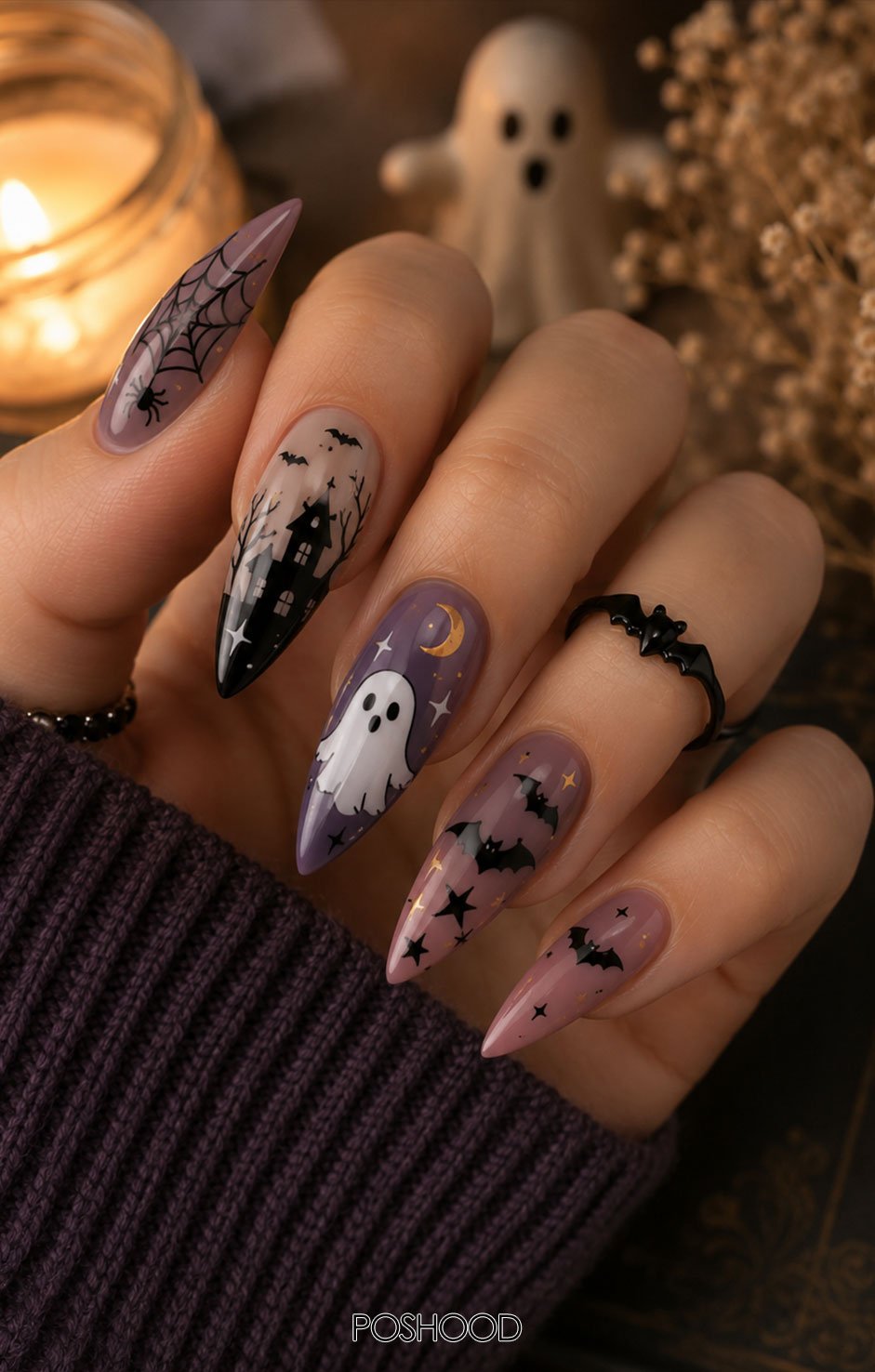 Matte black and purple almond-shaped Halloween nails featuring tiny haunted houses, glowing windows, flying bats, and a full moon against a dreamy twilight background.
