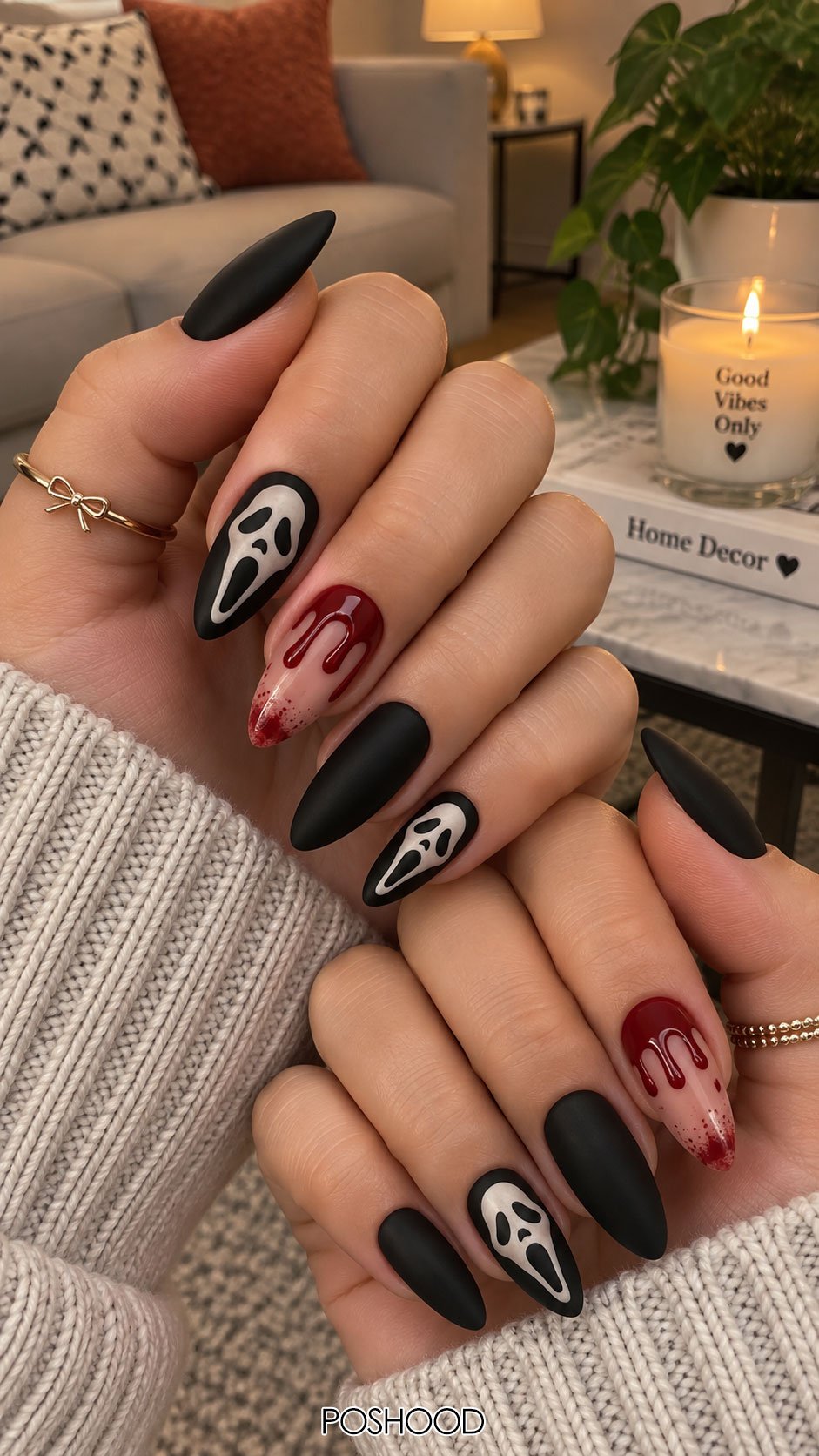 Cute Halloween nails ideas featuring black matte almond nails, white ghost face designs, and red dripping blood nail art.