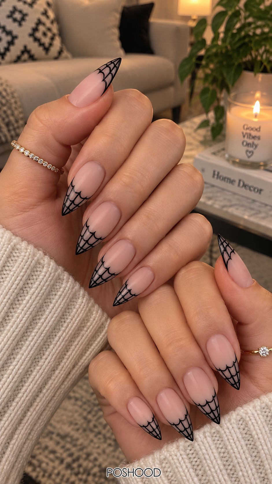 Cute Halloween nails ideas with nude pink almond nails and detailed black spider web French tip nail art.