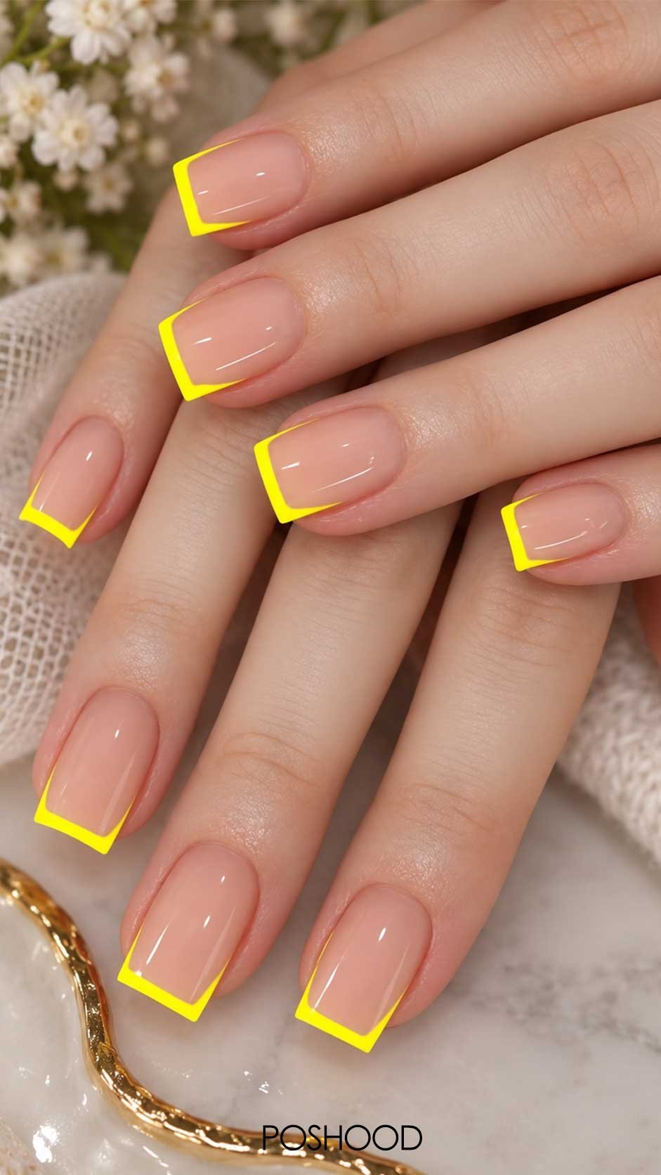 Glossy nude nails with bright neon yellow French tips in a square nail shape